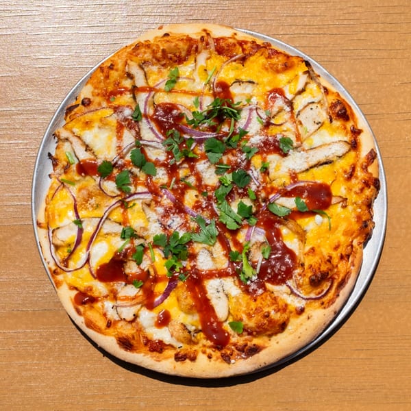 Tardino Brother's BBQ chicken pizza with red onions, cilantro, and a drizzle of sauce.