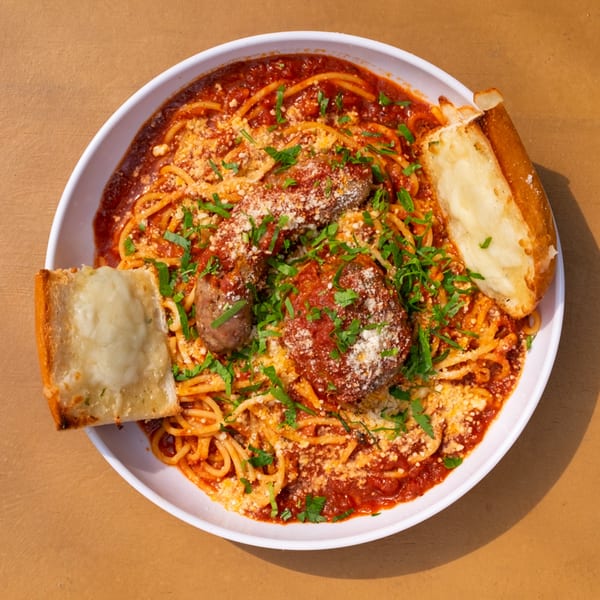 Tardino Brother's spaghetti with meatballs, sausage, marinara, parmesan, and garlic bread.